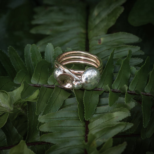 Brass spun ring, three twists with solid sterling silver nuggets.